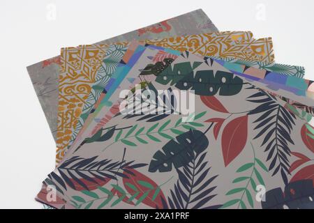 Multicolored patterned sheets of paper for origami on white background Stock Photo