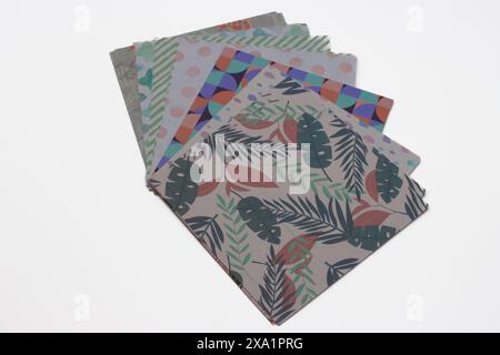 Multicolored patterned sheets of paper for origami on white background Stock Photo