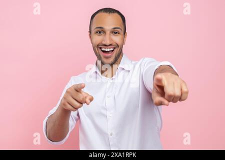 Excited man in white shirt pointing both fingers to camera Stock Photo