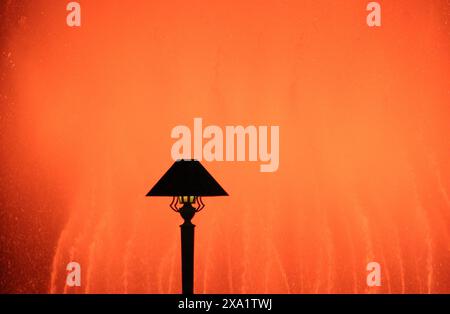 A lamp against a reddish glowing backdrop Stock Photo