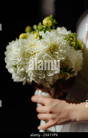 A bride holding her wedding bouquet prepared for the ceremony Stock Photo