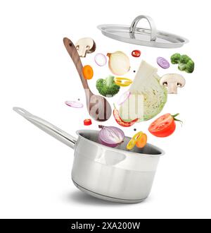 Fresh ingredients falling into saucepan on white background Stock Photo
