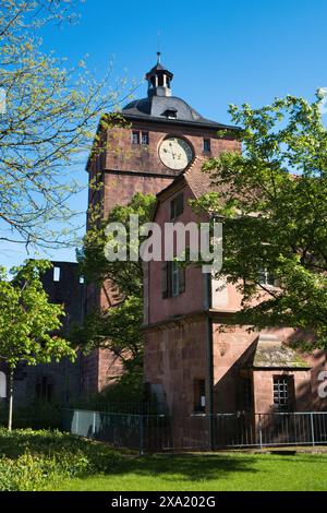 A Red brick building with a clock on its side, Heidelberg, Germany Stock Photo