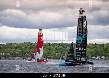 Boats from Team Canada and Team New Zealand racing during the June 2024 Sail GP event in Halifax, Nova Scotia, Canada. Stock Photo