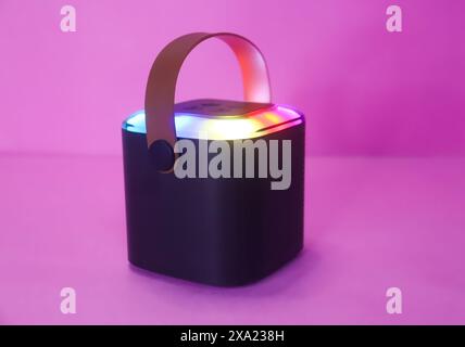 Hanging Bluetooth Speaker On The Pink Surface, Mini Speaker With Lights Stock Photo