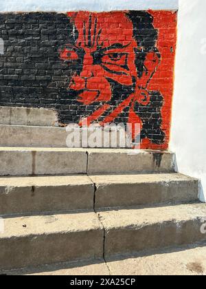 The graffiti art on brick wall near stairway Stock Photo