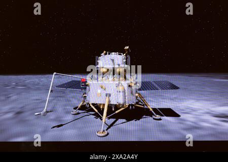 (240604) -- BEIJING, June 4, 2024 (Xinhua) -- This image taken from video animation at Beijing Aerospace Control Center (BACC) on June 4, 2024 shows the lander-ascender combination of Chang'e-6 probe waiting to lift off from lunar surface. A Chinese national flag carried by the lander is seen unfurled at the moon's far side. The ascender of China's Chang'e-6 probe lifted off from lunar surface on Tuesday morning, carrying samples collected from the moon's far side, an unprecedented feat in human lunar exploration history. The ascender has entered a preset orbit around the moon, said the Chi Stock Photo