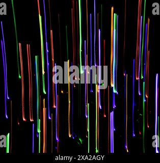 Colored lights with panning against a black background with a fire hydrant Stock Photo