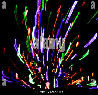 Colored lights with panning against a black background with a fire hydrant Stock Photo