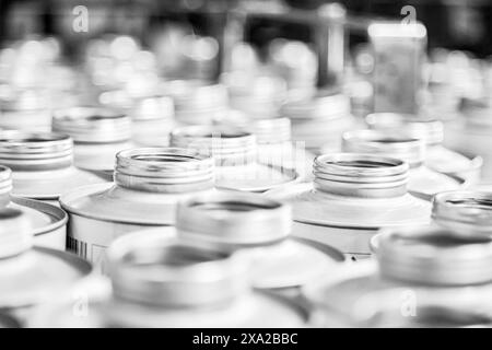 A close-up of empty cans in industrial setting in grayscale Stock Photo