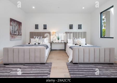 A cozy modern luxury bedroom with twin beds a luxurious comfortable chair with red leather upholstery and a spherical mirror Stock Photo Alamy