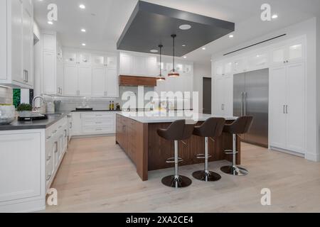 A modern kitchen with an island in a modern new construction home in Los Angeles Stock Photo