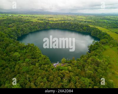 An aerial view of Rio Cuarto lake in Alajuela, Costa Rica, surrounded by dense greenery Stock Photo