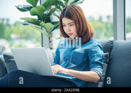Asian woman work from home social distancing quarantine people online meeting office team conference with video call office network. Woman working onl Stock Photo