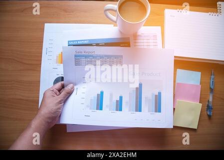Sales Managers Working Modern Studio.Woman Showing Hand Market Report Charts.Marketing Department Planning New Strategy.Researching Process Wood Table Stock Photo