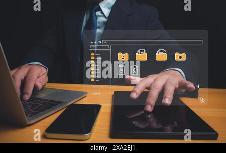 Businessman using a computer to document management, Document Management System (DMS) being setup by IT consultant working on laptop computer in offic Stock Photo