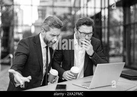 photo of amazed trader men freelancing online. two trader men freelancing online. Stock Photo