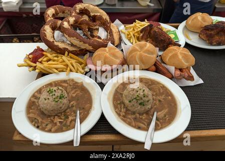 Tray with ordered marquee food, pretzels, baked Haendel, soup with liver dumplings, Leberkaessemmel, Allgaeu, Bavaria, Germany Stock Photo