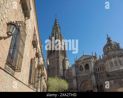 View of a gothic cathedral with a high tower and clear blue sky in the background, toledo, spain Stock Photo