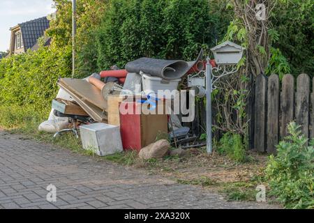 Pile of bulky waste on the side of the road with wooden furniture, drawers and laundry basket Stock Photo