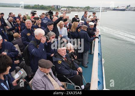 D-Day veterans gather on the deck of the Brittany Ferries ship Mont St Michel as it sails out of Portsmouth Harbour in the UK to Ouistreham, in Caen, France, carrying 31 D-Day and Normandy veterans who are travelling with the Royal British Legion and Spirit of Normandy Trust to take part in commemorations to mark the 80th anniversary of D-Day. Picture date: Tuesday June 4, 2024. Stock Photo