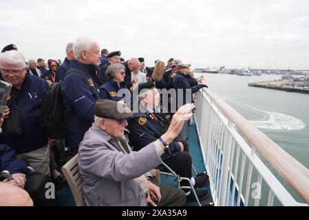 D-Day veterans gather on the deck of the Brittany Ferries ship Mont St Michel as it sails out of Portsmouth Harbour in the UK to Ouistreham, in Caen, France, carrying 31 D-Day and Normandy veterans who are travelling with the Royal British Legion and Spirit of Normandy Trust to take part in commemorations to mark the 80th anniversary of D-Day. Picture date: Tuesday June 4, 2024. Stock Photo