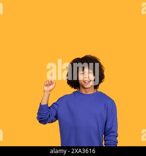 Man in Blue Shirt Holding Hand Up Stock Photo