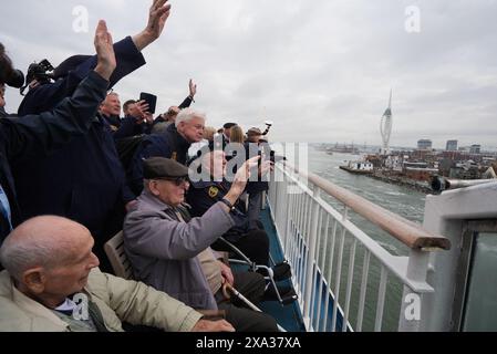 D-Day veterans including Richard Aldred (centre) gather on the deck of the Brittany Ferries ship Mont St Michel as it sails out of Portsmouth Harbour in the UK to Ouistreham, in Caen, France, carrying 31 D-Day and Normandy veterans who are travelling with the Royal British Legion and Spirit of Normandy Trust to take part in commemorations to mark the 80th anniversary of D-Day. Picture date: Tuesday June 4, 2024. Stock Photo