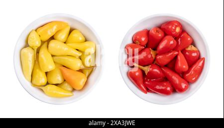 Pickled yellow and red hot baby peppers, in white bowls. Small hot chilis, pepperonis, Capsicum pepper, pasteurized and preserved in vinegar brine. Stock Photo