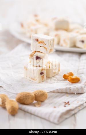 Soft nougat with peanuts on a plate, chewy sweets  with nuts Stock Photo