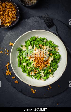German egg noodles - Spinach spaetzle with parmesan and roasted onions Stock Photo
