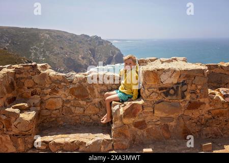 Family with children, siblings, visiting the most west point of Europe, Cabo Da Roca, during family vacation summertime in Portugal Stock Photo