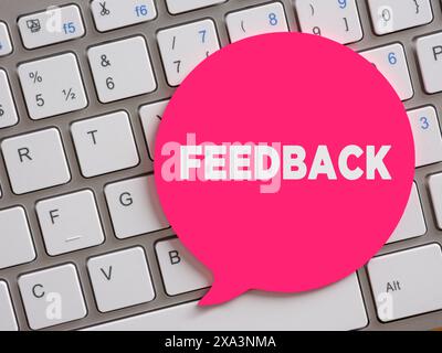 The word feedback on speech bubble over computer keyboard. Stock Photo