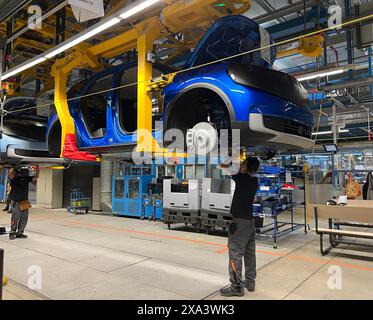 Cologne, Germany. 04th June, 2024. A Ford employee works on a body of the first Ford Explorer electric car to be manufactured in Cologne, whose series production began on Tuesday. Credit: Wolf von Dewitz/dpa-Zentralbild/dpa/Alamy Live News Stock Photo