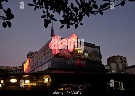 Harry's pink neon sign at the famous Cafe De Wheels pie cart caravan at Woolloomooloo, late afternoon,  illuminated in rich colours, Sydney, Australia Stock Photo