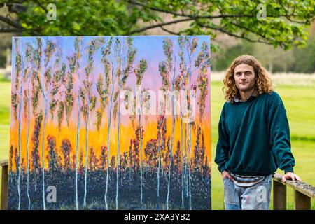 Artist Joe Grieve with one of his large colourful paintings at the first art exhibition at Colstoun House, East Lothian, Scotland, UK Stock Photo