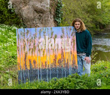 Artist Joe Grieve with one of his large colourful paintings at the first art exhibition at Colstoun House, East Lothian, Scotland, UK Stock Photo