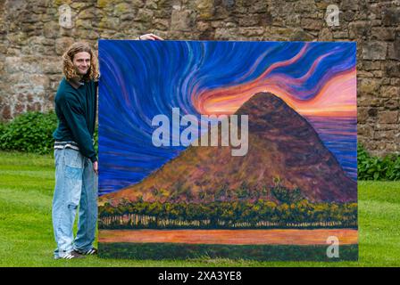 Artist Joe Grieve with one of his large colourful paintings at the first art exhibition at Colstoun House, East Lothian, Scotland, UK Stock Photo