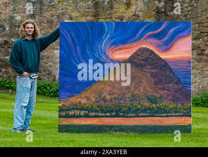 Artist Joe Grieve with one of his large colourful paintings at the first art exhibition at Colstoun House, East Lothian, Scotland, UK Stock Photo