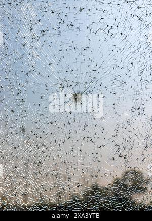 Broken windshield of a car close-up as a background. Texture broken glass with cracks. Stock Photo