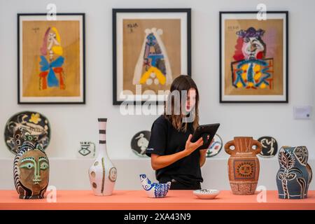 London, UK. 4th June, 2024. An art handler does a final check of various Picasso works - Phillips, London, Preview of the Pablo Picasso Paper and Clay Auction and Evening & Day Editions Auction. They take place on 6-7 June. Credit: Guy Bell/Alamy Live News Stock Photo