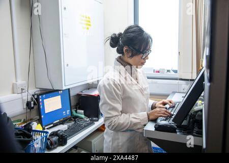 Scientist working at computer in lab of a medical practice, UK Stock Photo