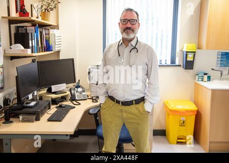 Doctor standing confidently in his office Stock Photo