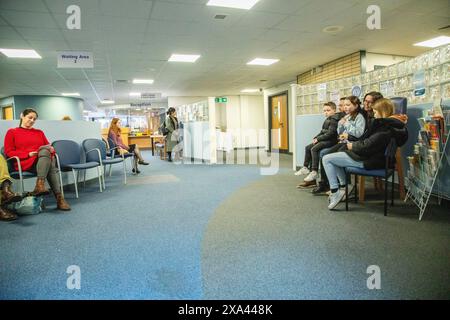 People waiting in a waiting room of a medical practice Stock Photo