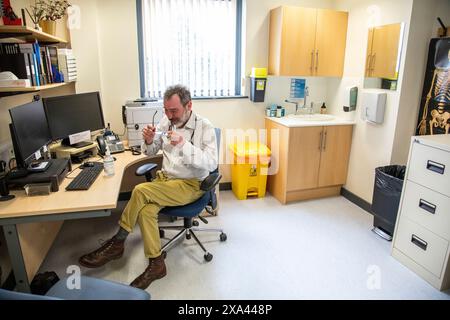 Doctor working at a desk in a medical office Stock Photo