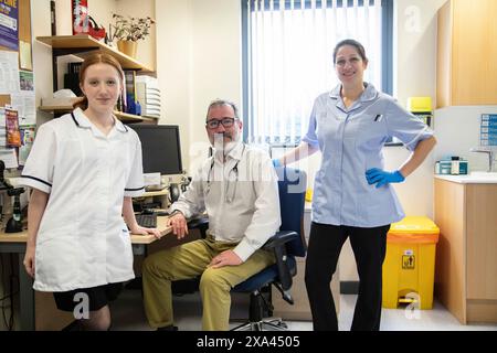 Three healthcare professionals in a medical office Stock Photo