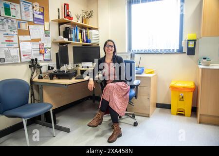 Doctor smiling in her office in medical practice Stock Photo
