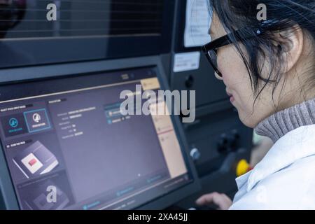 Woman using a touchscreen panel in a medical practice Stock Photo