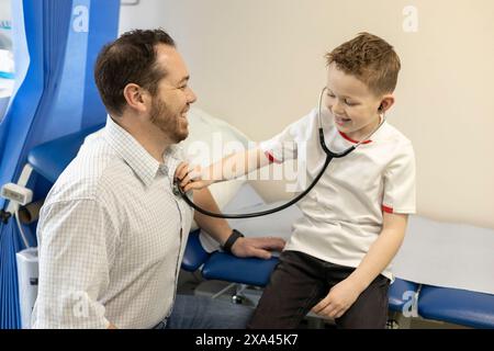 Child playing doctor with an adult doctor Stock Photo