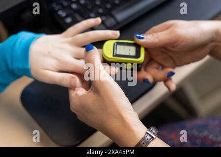 Two people checking a handheld electronic device. Stock Photo